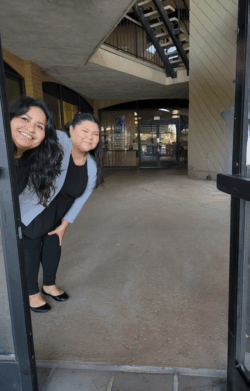 ADRC Team Members Mareli and Esme peeking out door.