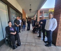 DMC Leadership Team: L-R: Christine, Michael, Ivan, Pamela, Jackie, Marisol, Nelly, Paul, and Miguel outside in open welcoming circle smiling in support.
