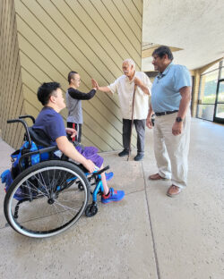DMC Board President Tony giving a “high-five” to Mason, a DMC Youth Connect participant as Board VP, David and DMC Youth Connect Participant, Sean smile in sharing the moment.
