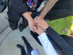 DMC Admin hands (Christine, Michael, Jackie and Miguel) united ‘all-in this together’ stacked on top in team spirit