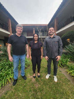 Deaf Services Team Jet, Pamela and Tobias outside in courtyard