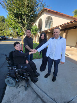 DMC Administrative Team with all hands in unity L-R: Christine Nguyen, Financial Administrator, Michael Susi, HR Generalist, Jackie Castro, Billing Administrator, and Miguel Escargaza, DMC Operations and IT Administrator