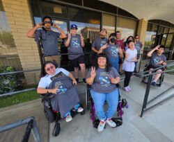 DMC Summer Youth Academy participants with Team DMC Youth Connect outside of DMC on ramp smiling, wearing Summer Youth Academy shirts, having fun connecting